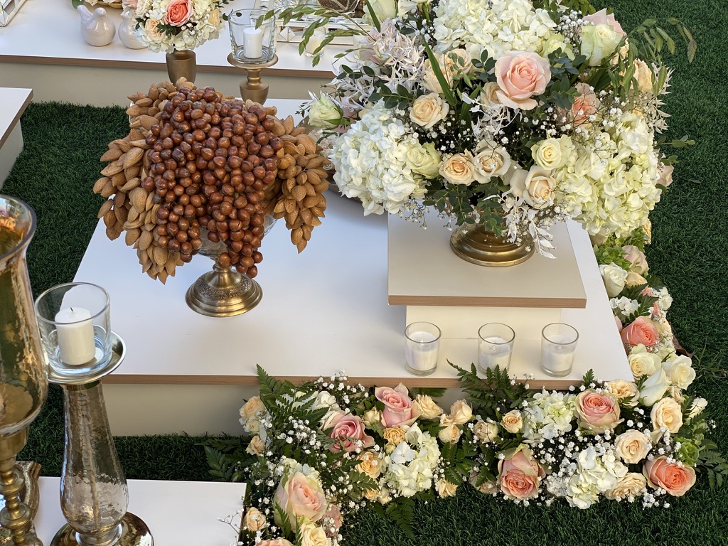 A table adorned with colorful flowers and lit candles, creating a warm atmosphere for Mother's Day celebration.