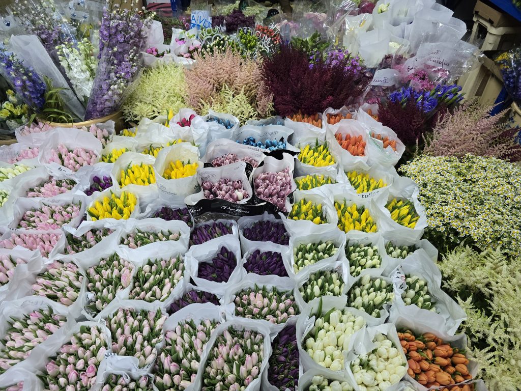 A vibrant assortment of flowers in bags, highlighting affordable fresh flower offerings in Dubai.