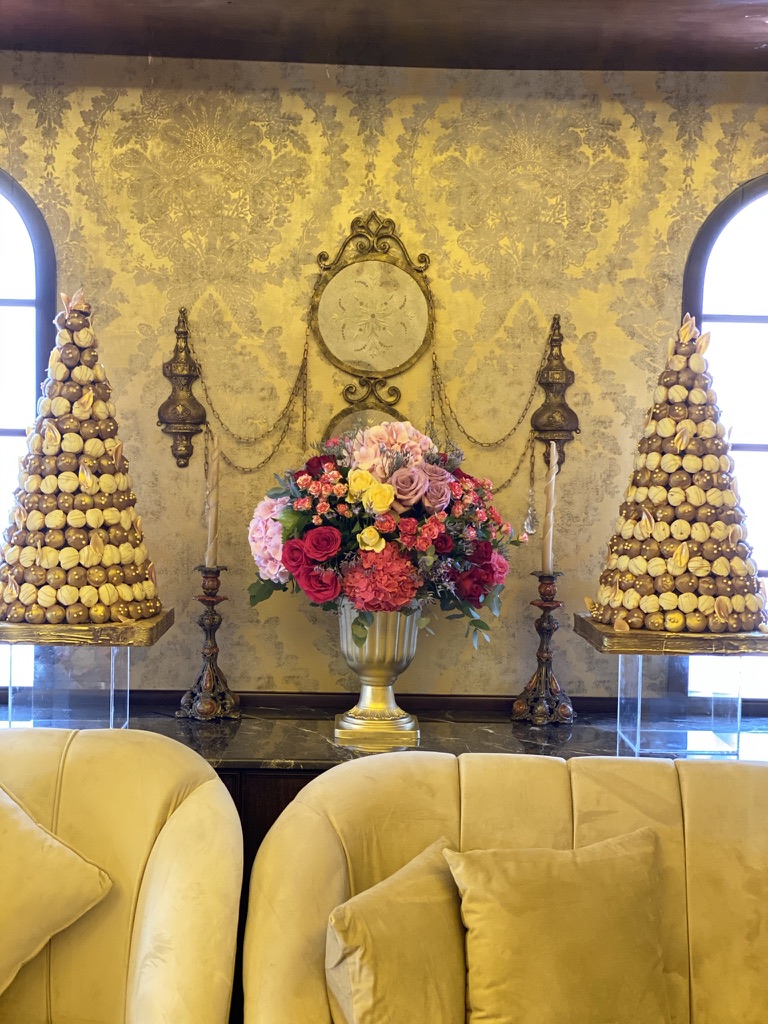 Large room with a couch and two chairs, adorned with decorations for UAE's National Day.