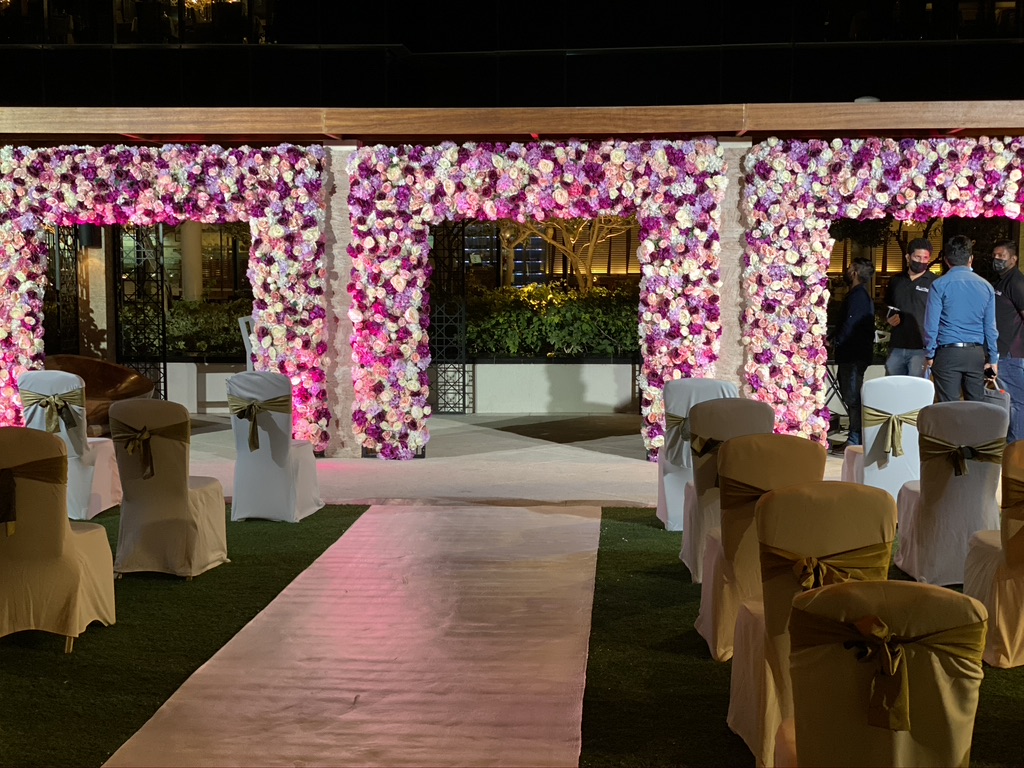 Elegant wedding ceremony setup adorned with spring-themed pink and white flowers, creating a romantic atmosphere.