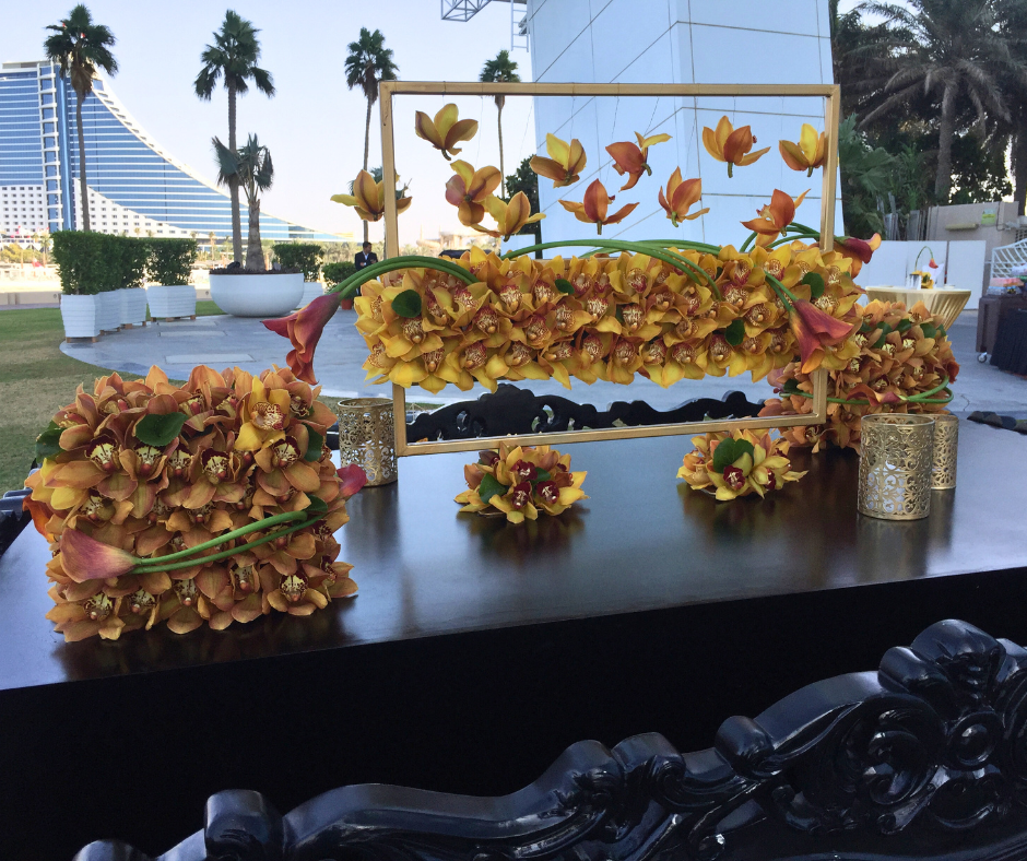 A table decorated with an array of vibrant flowers, set for a wedding at the iconic Burj Al Arab.