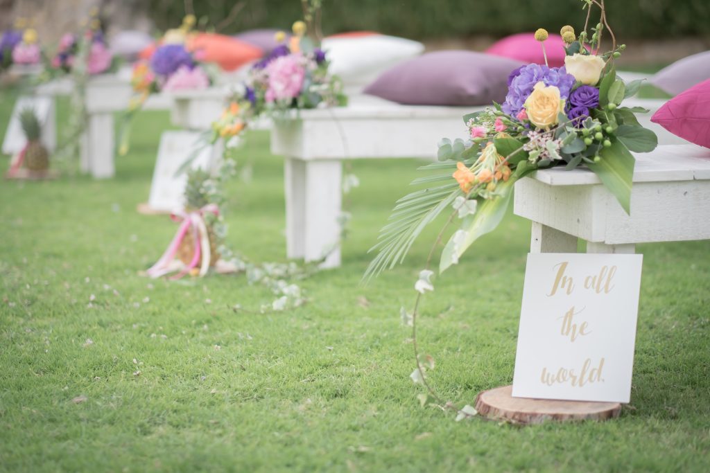 A vibrant floral arrangement displayed on a wooden bench, showcasing popular flower trends in Dubai.